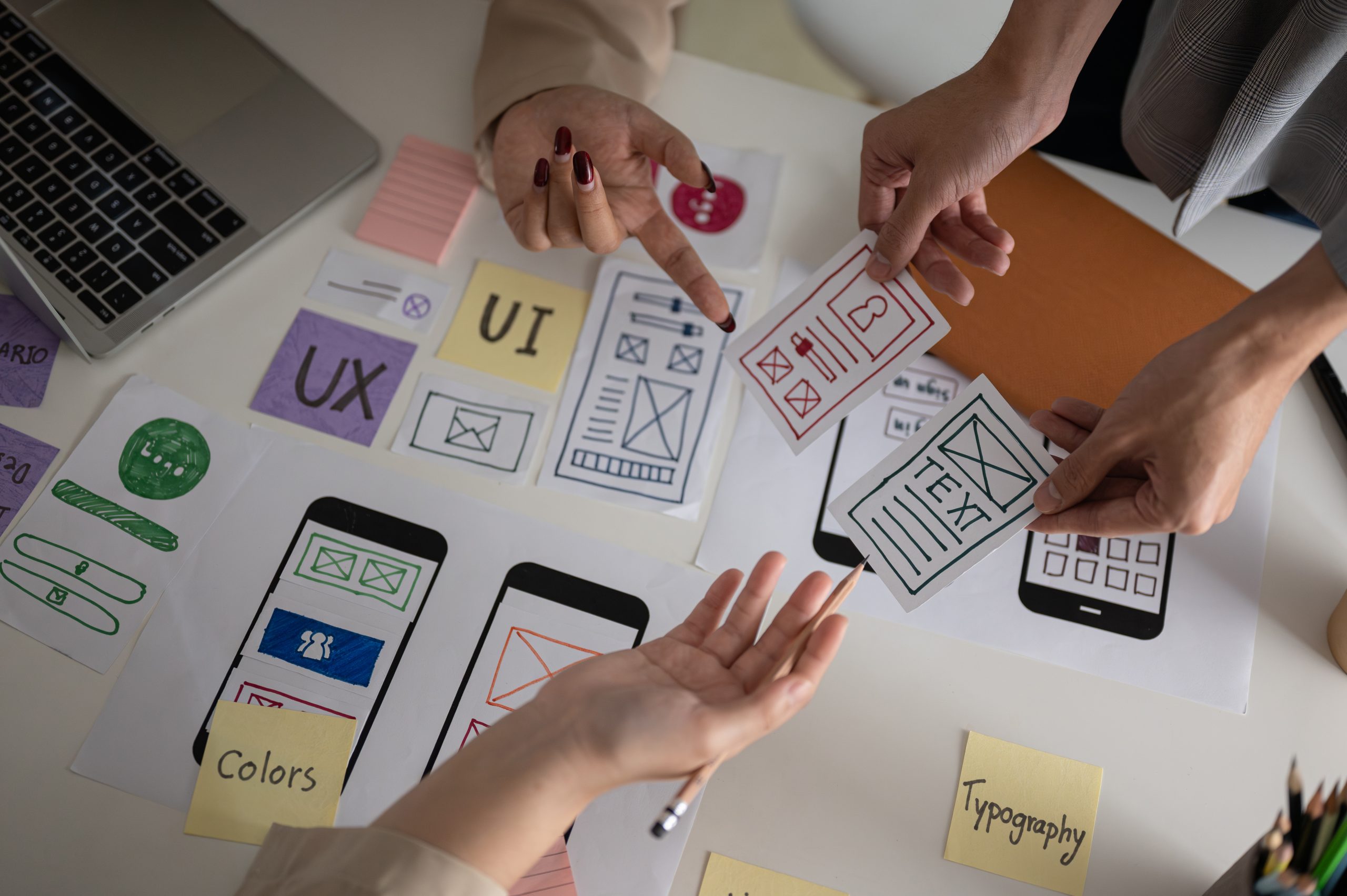 User Centric Design in Education Technology: A Guide to Building Impactful Products 2 Top view image of a UX UI graphic designer team voting a perfect prototype in the meeting.