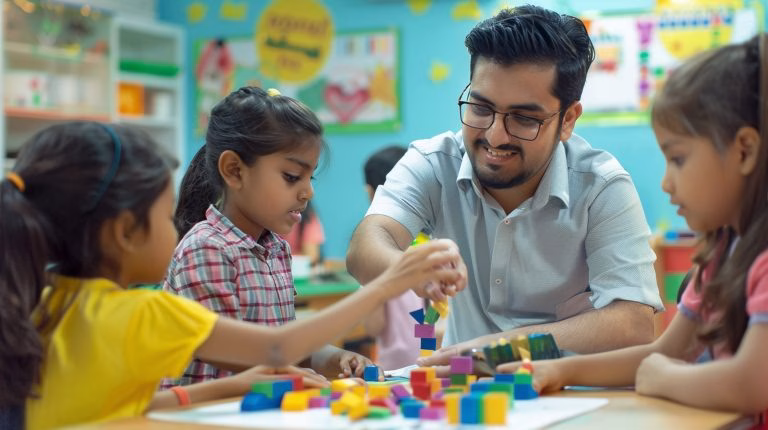 Teacher assisting children with blocks